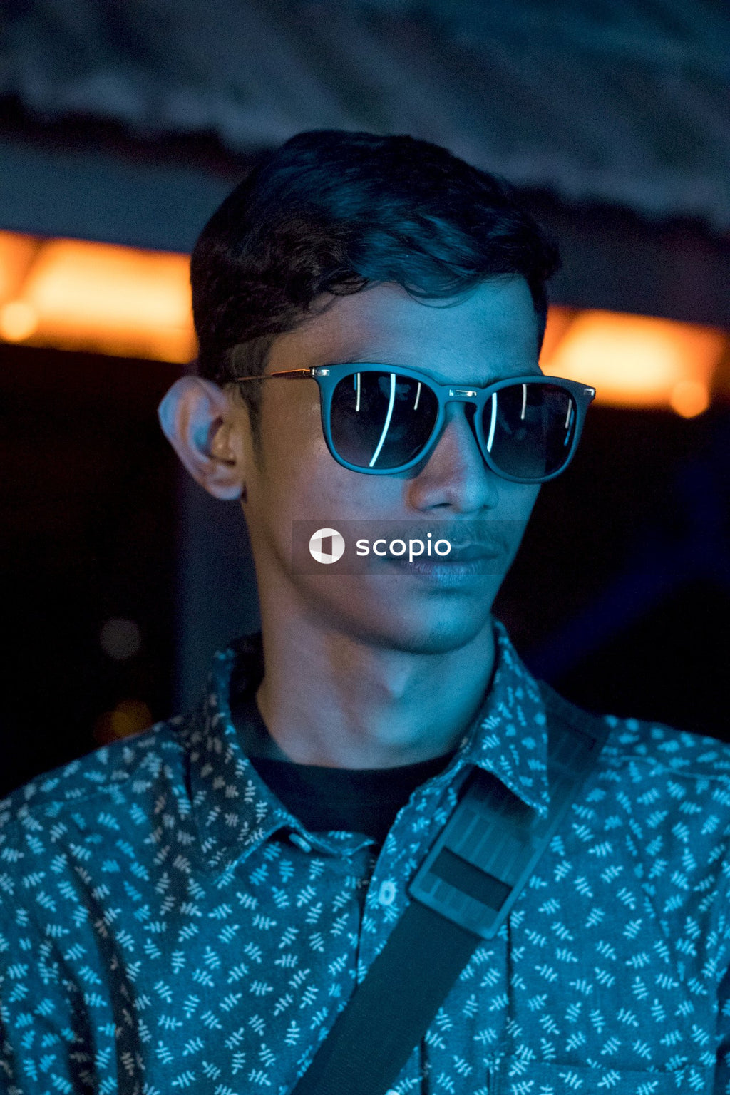 Man in Blue and White Button up Shirt Wearing Black Framed Eyeglasses