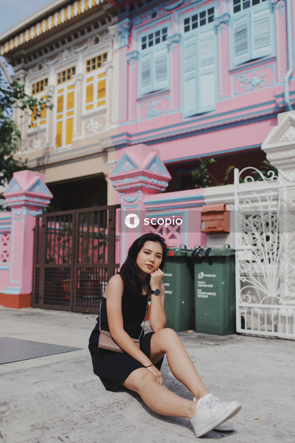 Black Dress and White Shoes Contrasting With Colorful Wall