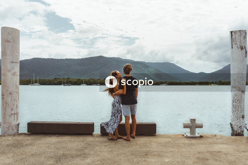 Man and woman overlooking sea and mountain view