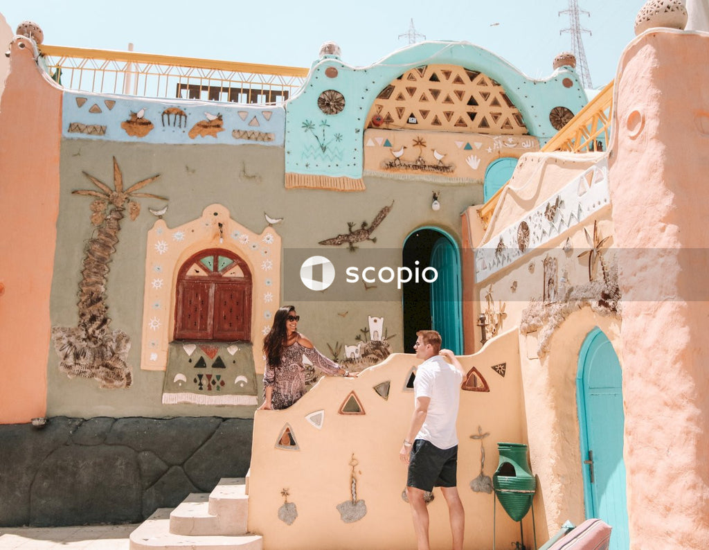 Couple in front of colorful house