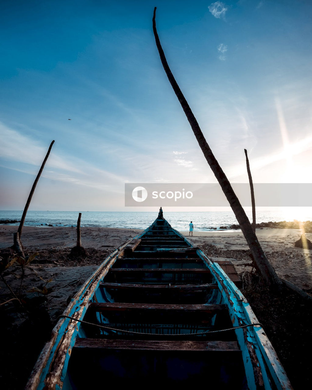 Blue Boat on White Sand Beach Kissed by Wave