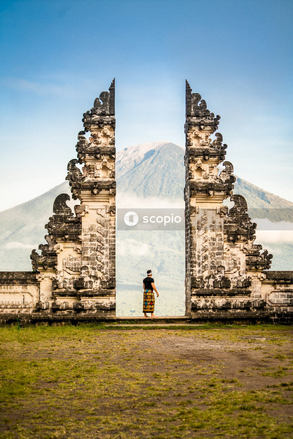 Man standing between temple Pura Penataran Agung Lempuyang, Indonesia