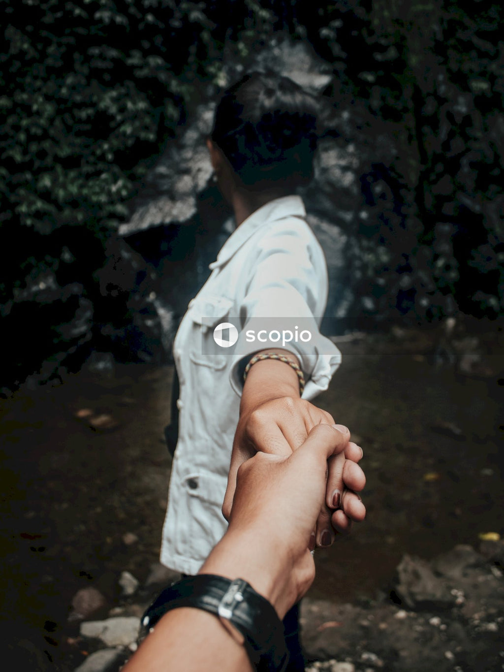 Woman in a white shirt holding hand of a man