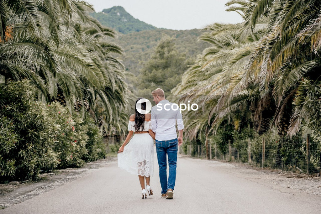 Couple kissing on gray asphalt road