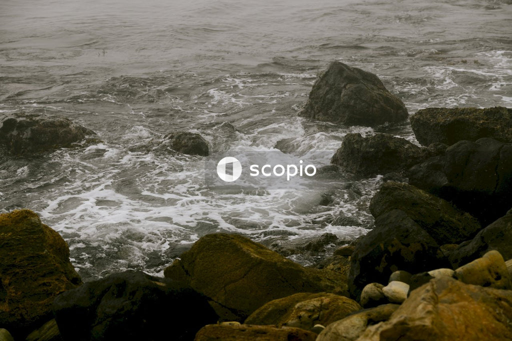 Brown rock formation on sea