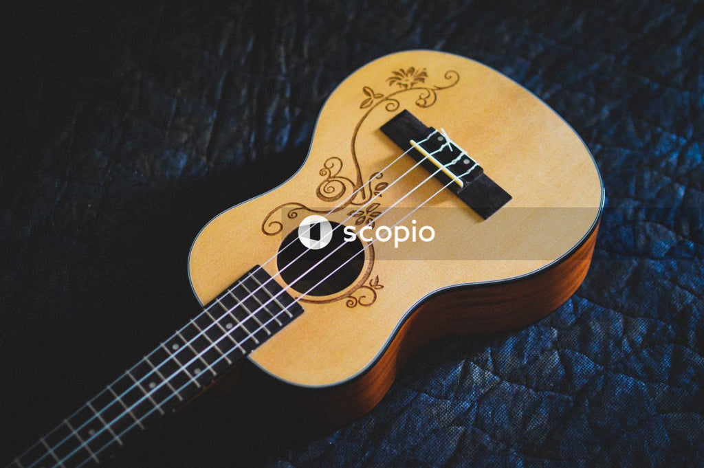 Brown acoustic guitar on black textile