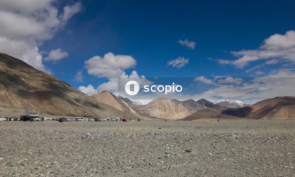 Brown and white mountains under blue sky