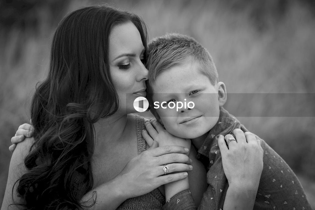 Grayscale photo of woman hugging girl