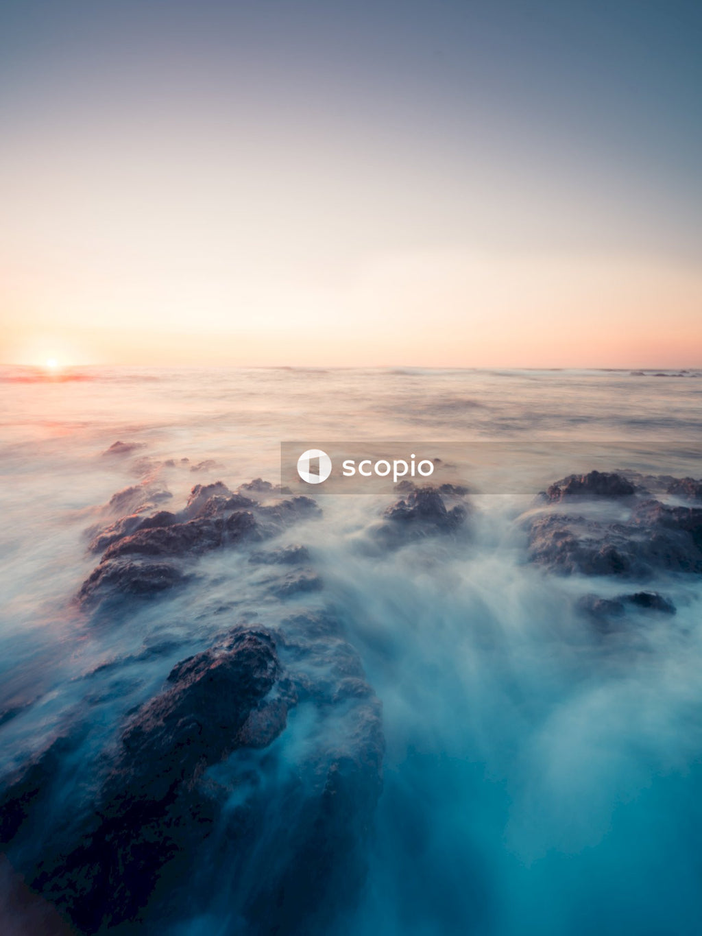 Ocean waves crashing on shore during sunset