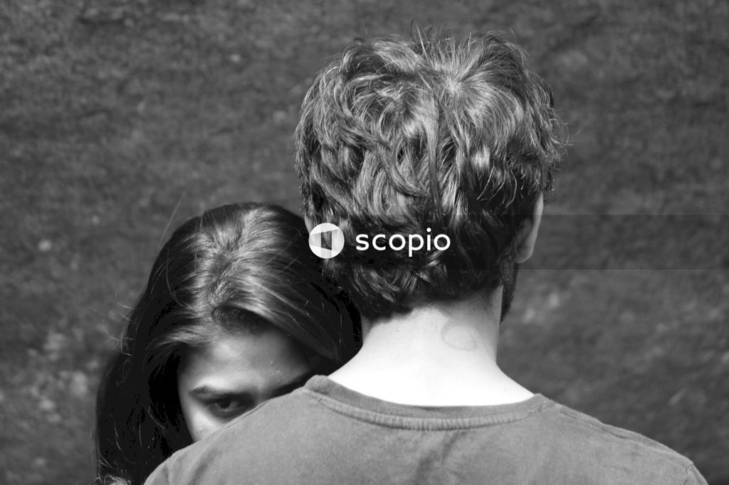 Grayscale photo of man and woman hugging