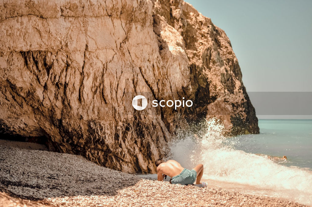 Woman lying on brown sand near body of water