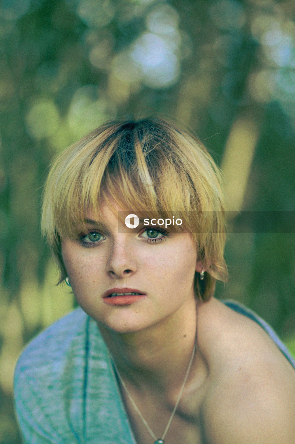 Portrait of young woman in blue shirt outdoor