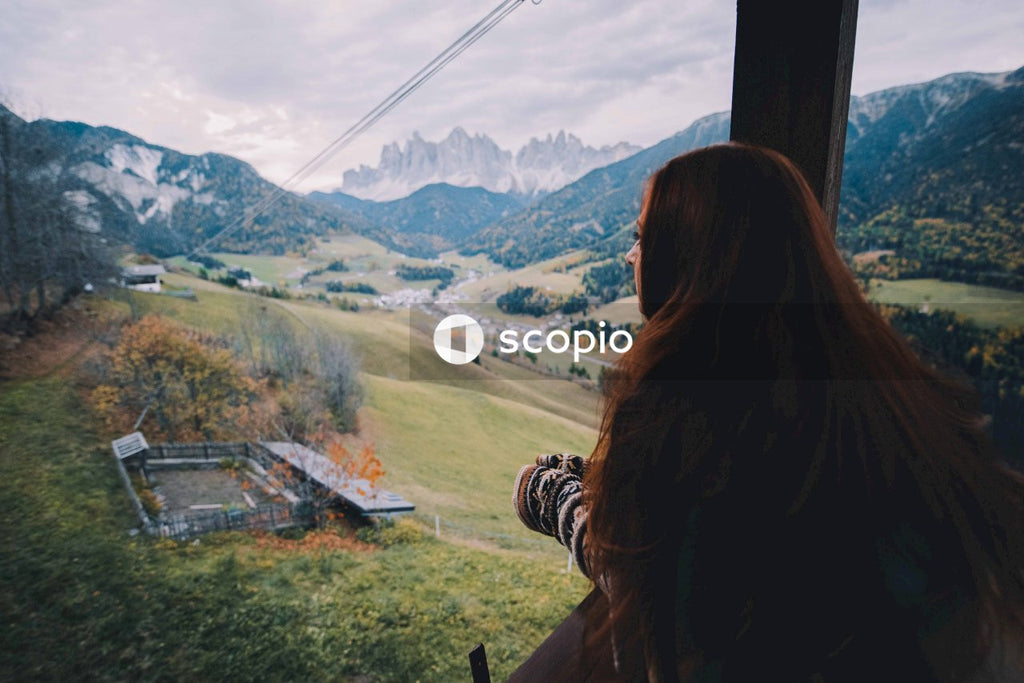 Woman standing overlooking mountains from the balcony