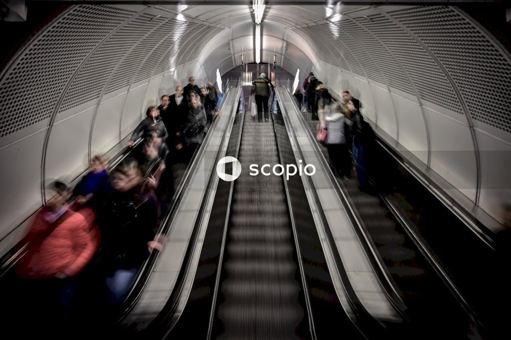 People walking on escalator inside building