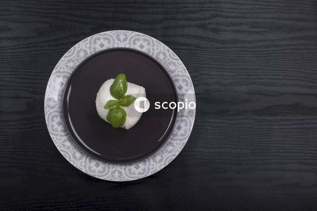 Green leaf on white and blue floral ceramic plate