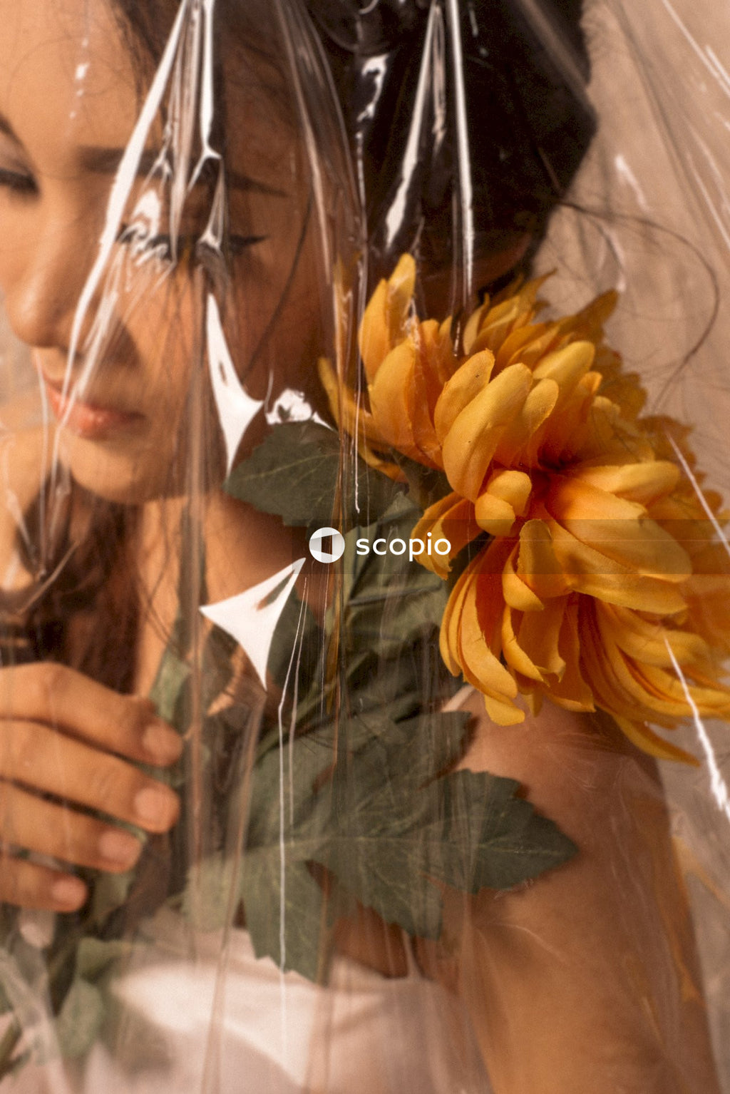 Portrait of woman pitting flowers on her shoulder
