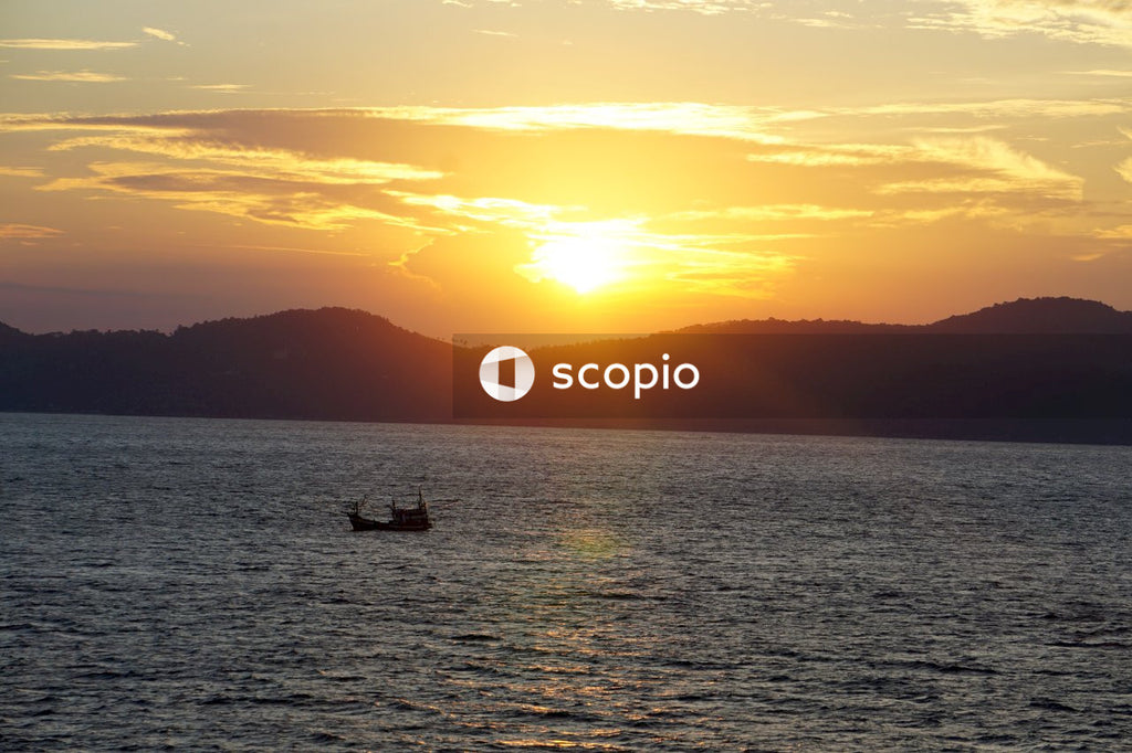 Silhouette of boat on sea during sunset