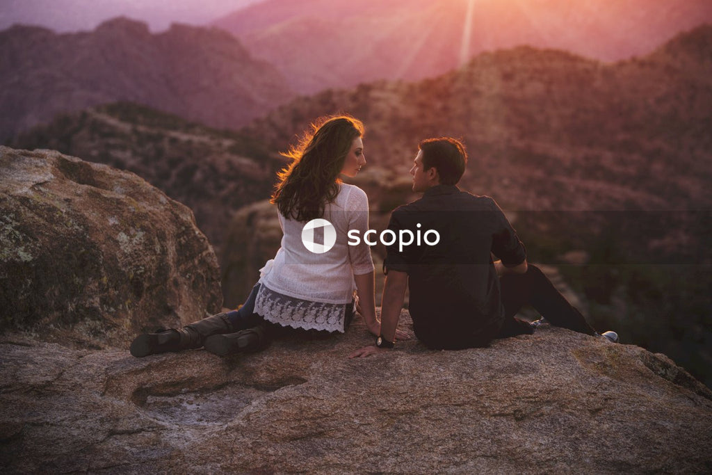 Couple Overlooking the Sunset From Mountaintop
