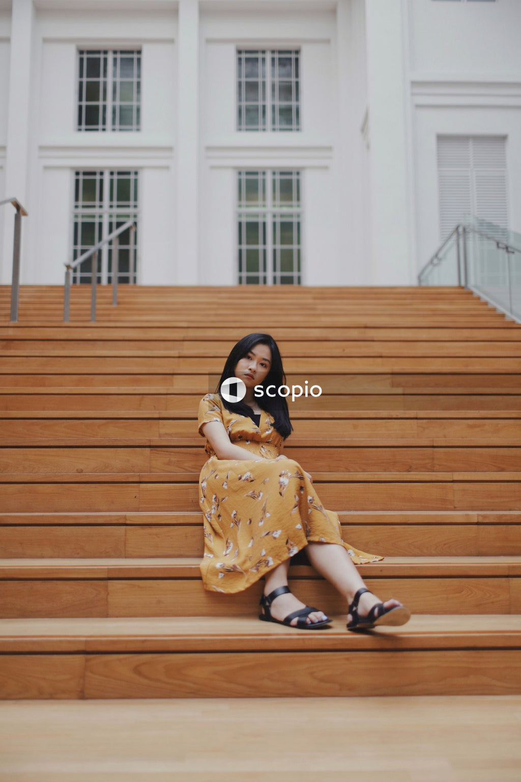 Woman in long orange dress on stairs