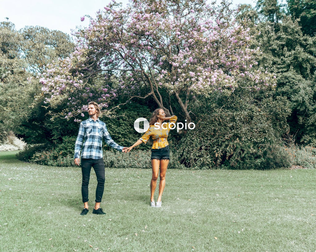 Man and woman standing on green grass field at daytime