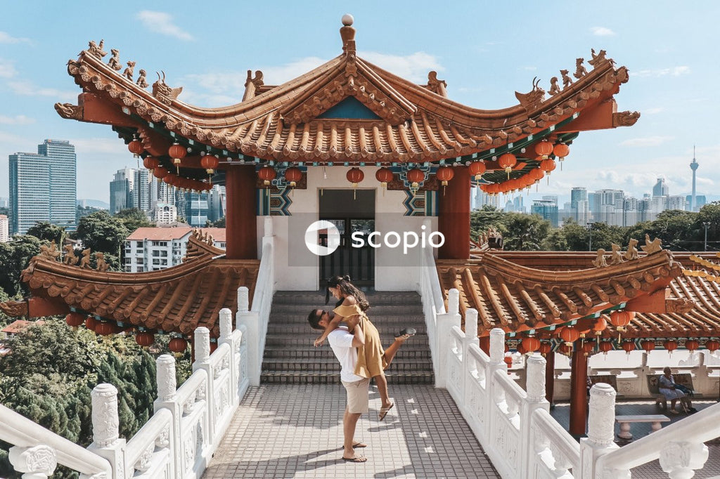 Man carrying woman outside of Thean Hou Temple in Kuala Lumpur, Malaysia