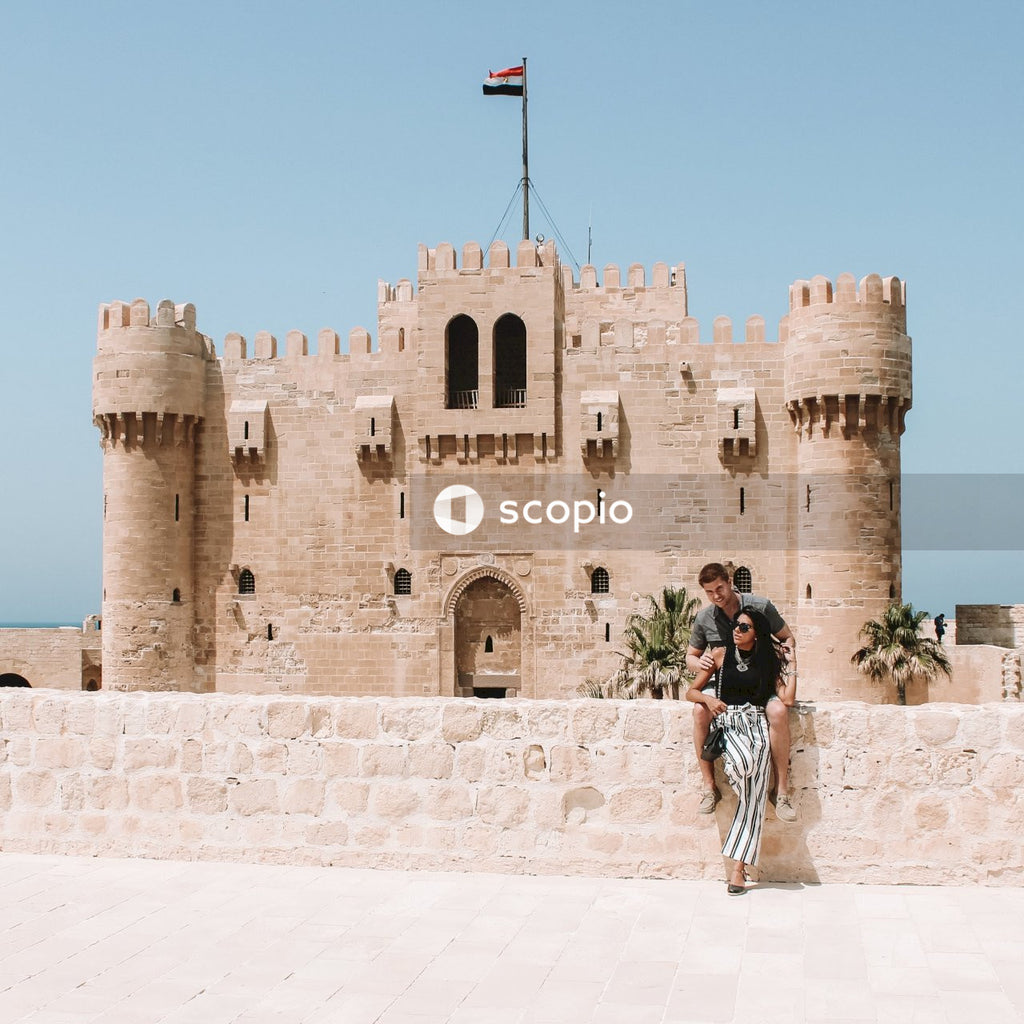 Couple sitting near Citadel of Qaitbay in Alexandria, Egypt