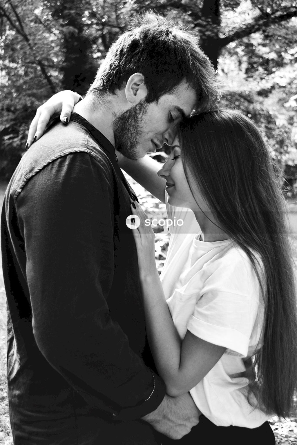 Grayscale photo of man and woman hugging