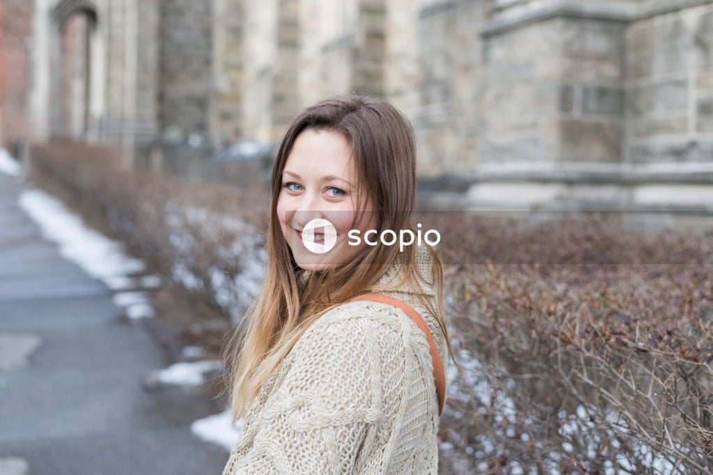 Woman in white knit cardigan smiling