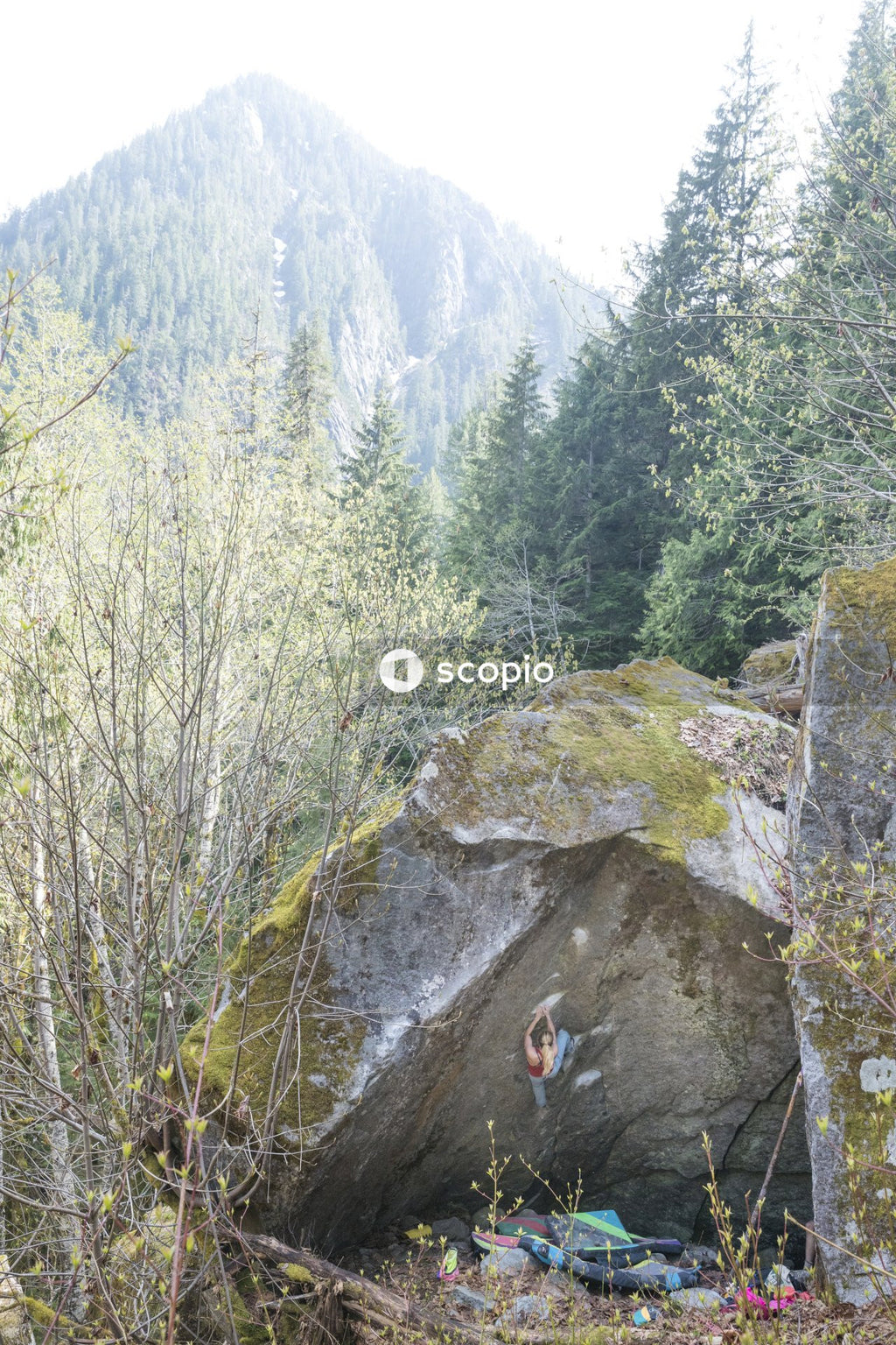Girl climbing high rock