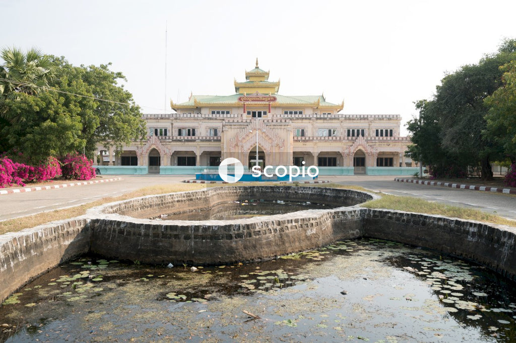 Brown concrete building near water fountain