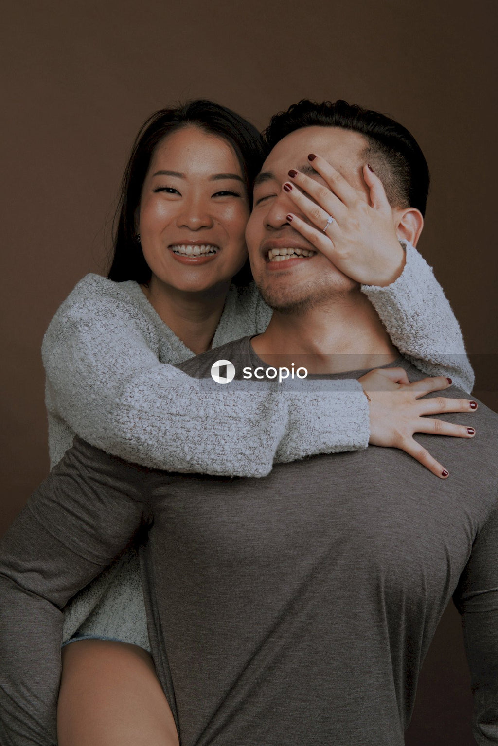 Man and woman smiling while hugging