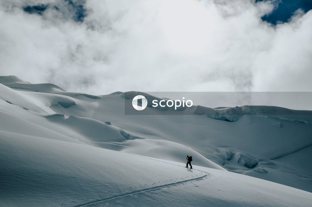 Person with backpack walking on snow covered ground
