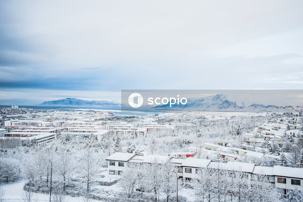 Snow covered mountain under cloudy sky