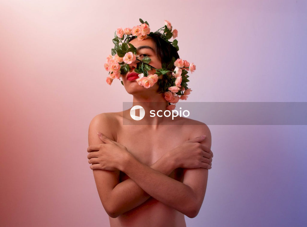 Topless man wearing multiple artificial flower crowns on her head