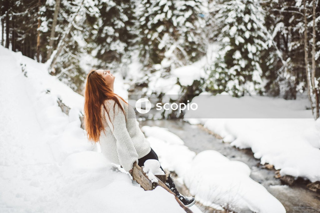 Woman in light sweater enjoying snow