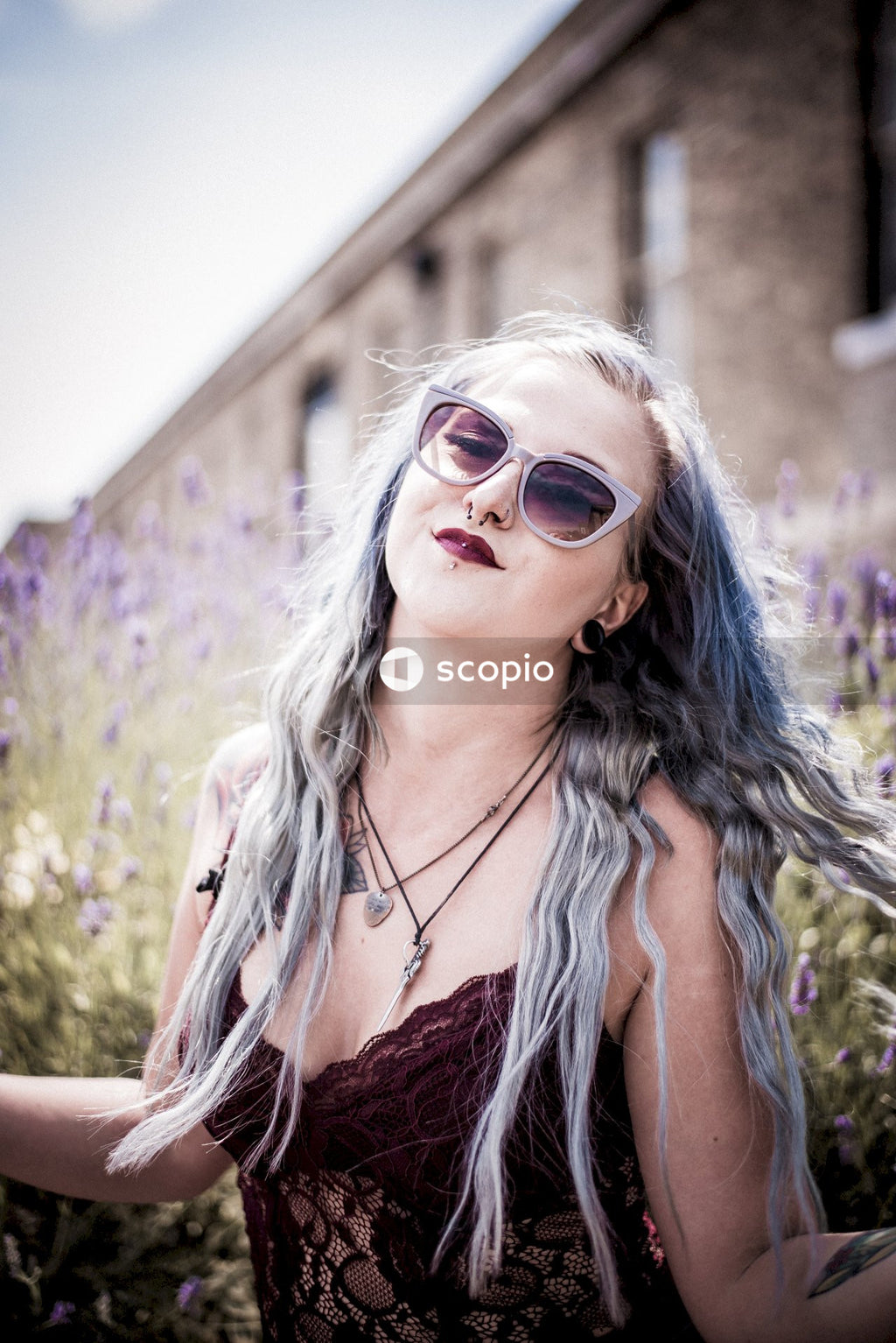Woman in orange tank top wearing sunglasses