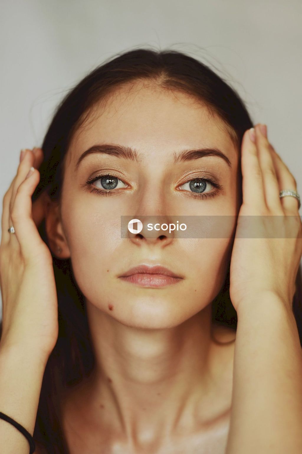 Brunette woman posing holding her head