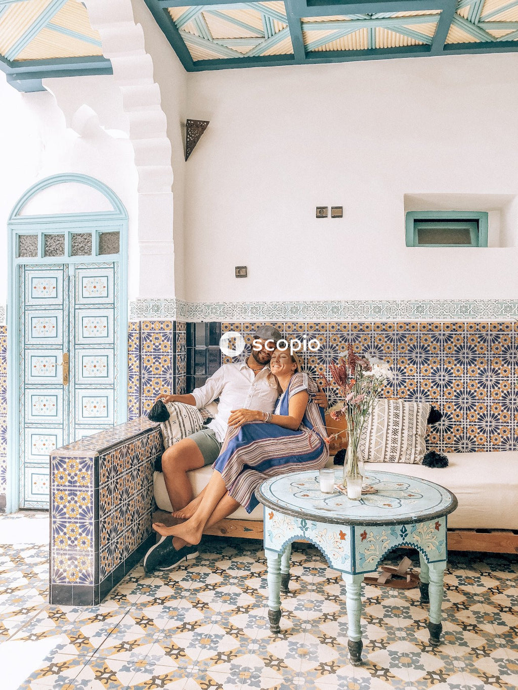 Couple sitting on sofa beside table