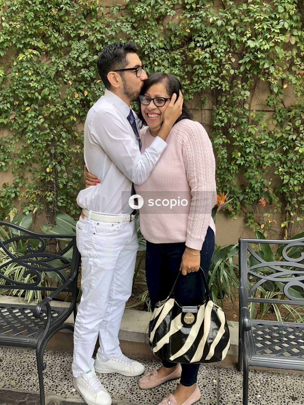 Man in white dress shirt standing beside woman in pink sweater