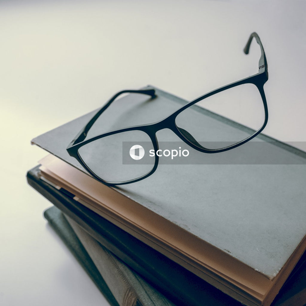 Black framed eyeglasses on blue book