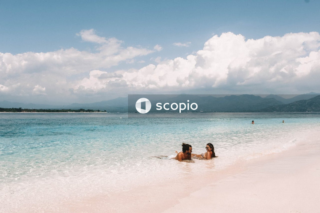 Man and woman laying on seashore