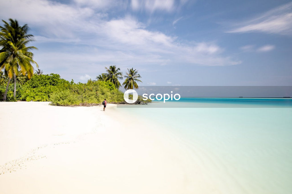 Woman in white dress walking on beach