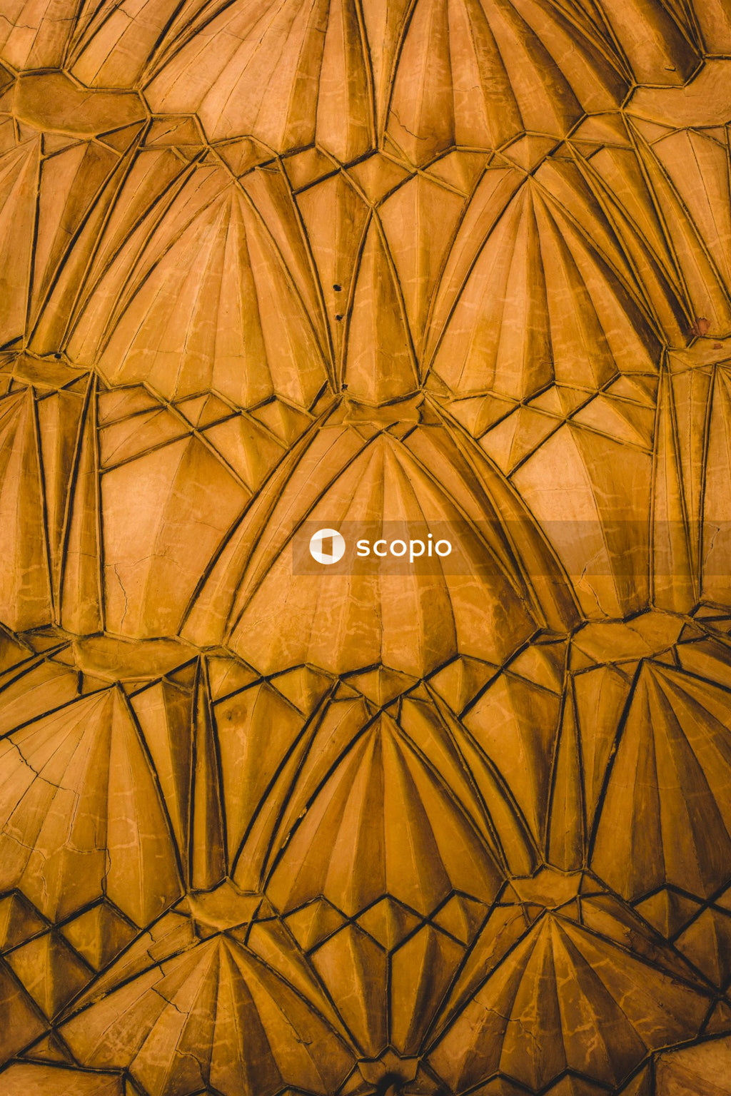 Interior shot of yellow carved concrete dome