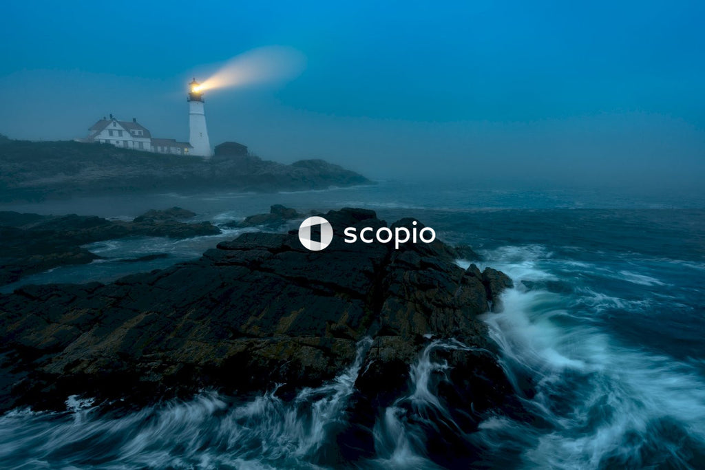 White lighthouse on brown rock formation near sea