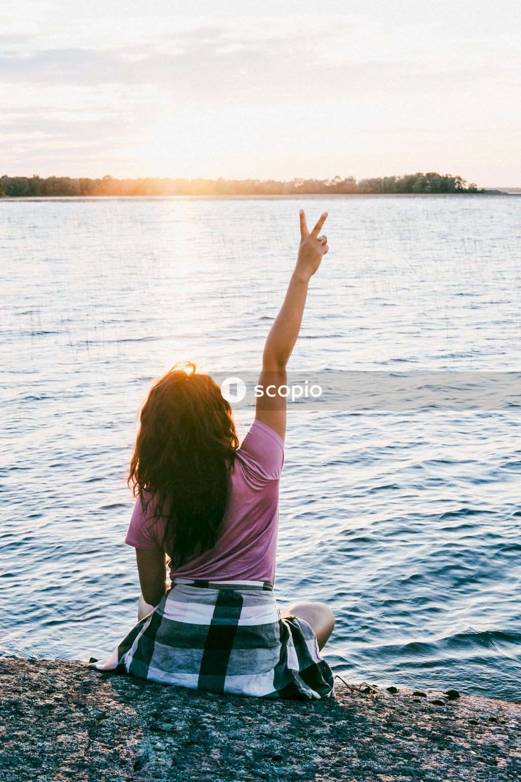 Woman in pink shirt sitting on boat