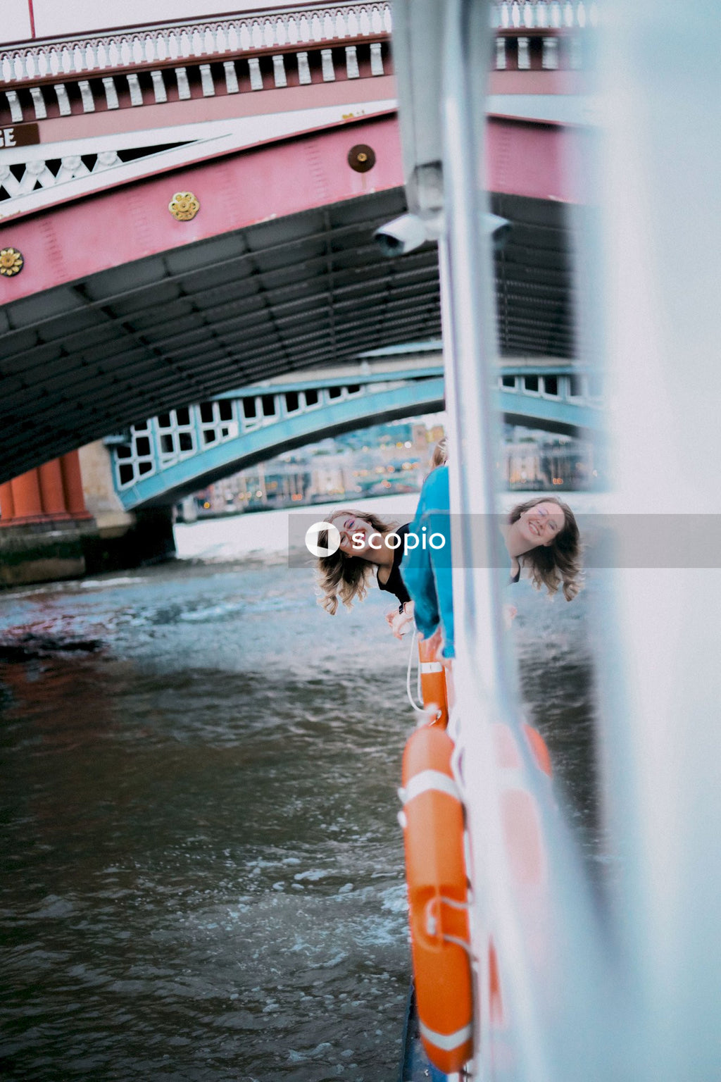 Woman in blue and white dress standing on water