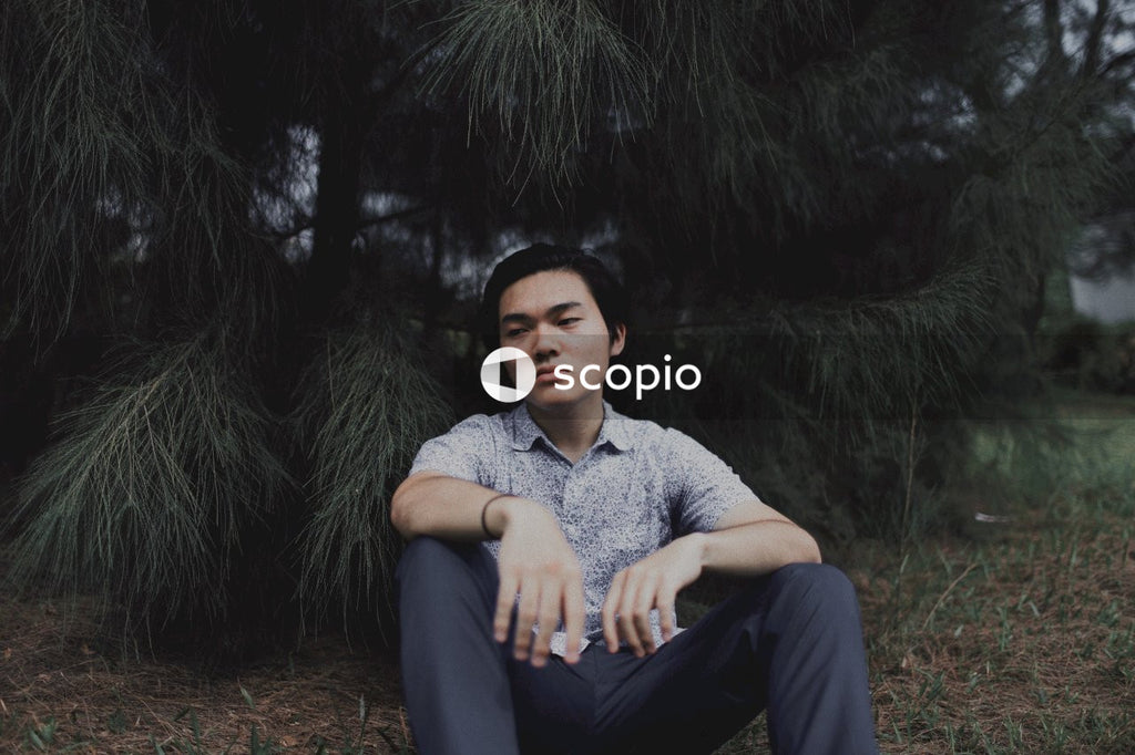 Man sitting on the floor under a tree