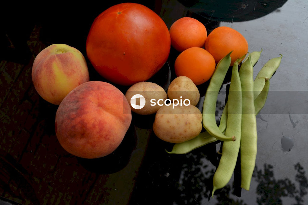 Red round fruit on black surface