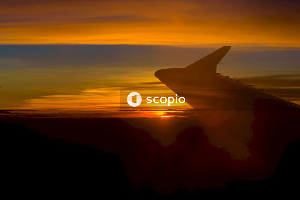 Silhouette of airplane wing during sunset