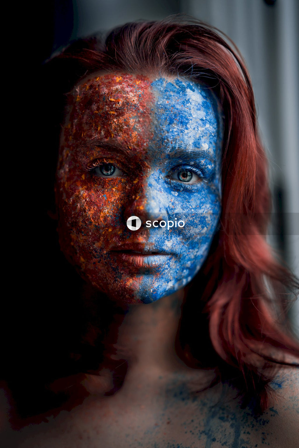 Woman with blue and red face paint